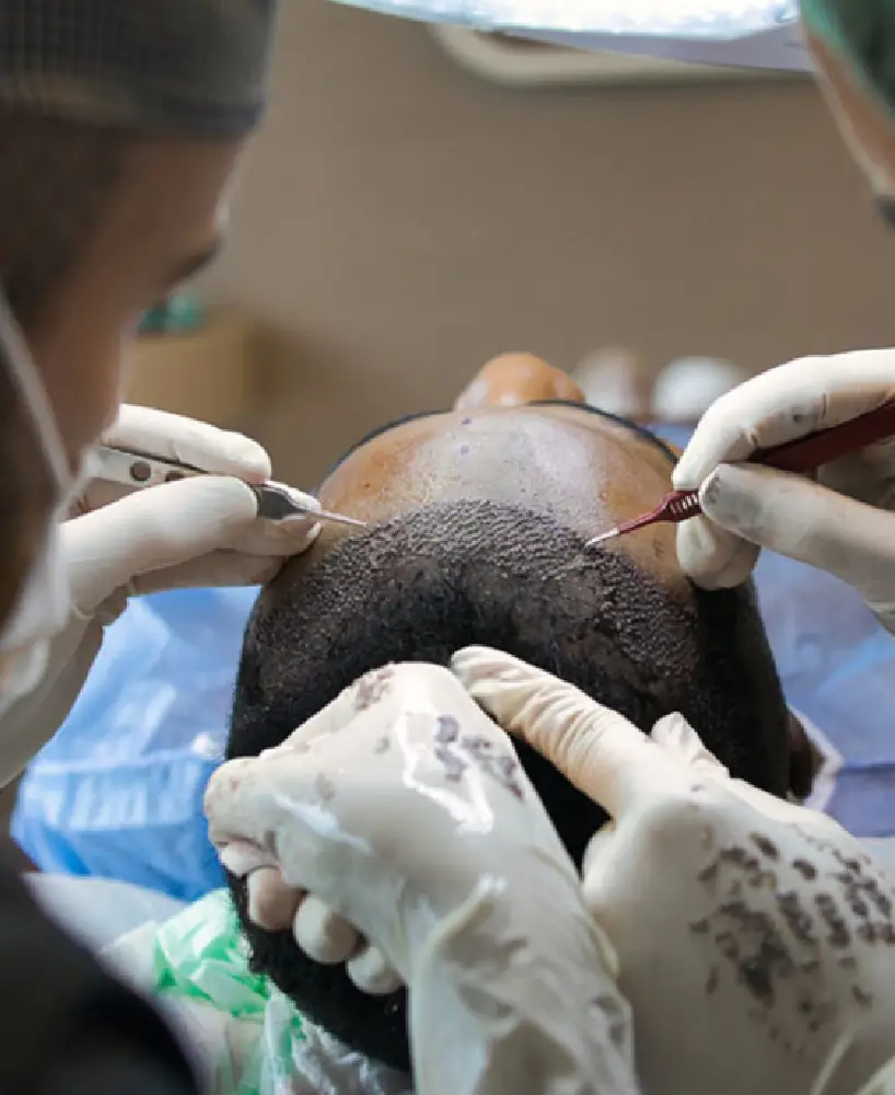 A person getting their hair cut by an esthetician.